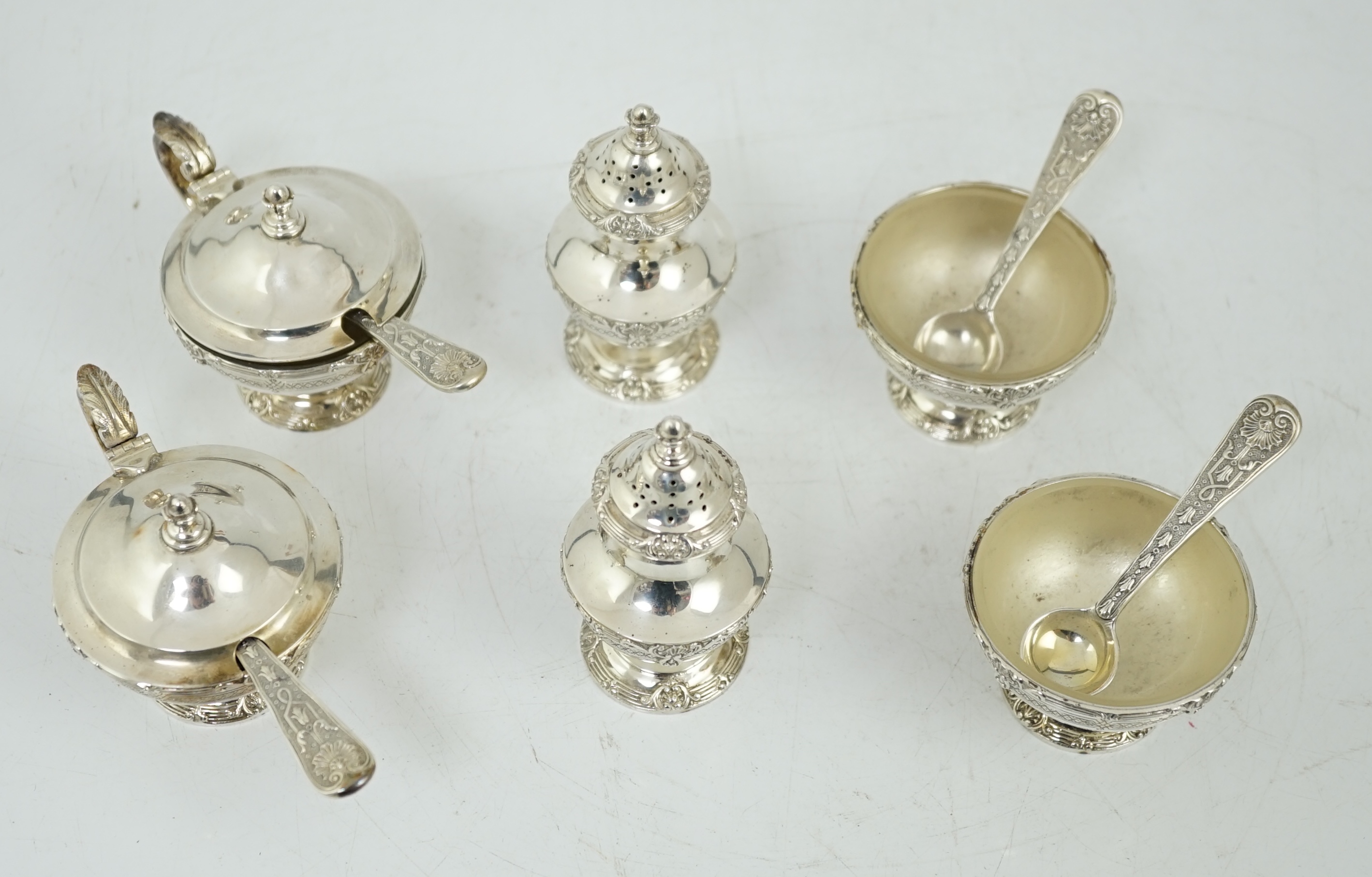 An Elizabeth II cased silver six piece pedestal condiment set, with four matching spoons, by Garrard & Co